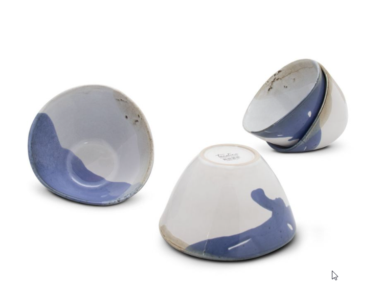 Blue and white ceramic bowls stacked on a white background