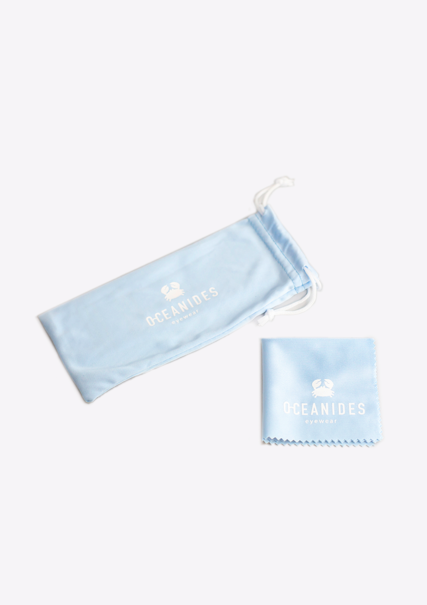A light blue drawstring pouch and matching cleaning cloth, both with the white Oceanides logo, shown on a white background—ideal for your Perse Crystal Baby Blue Polarized Sunglasses by Oceanides.