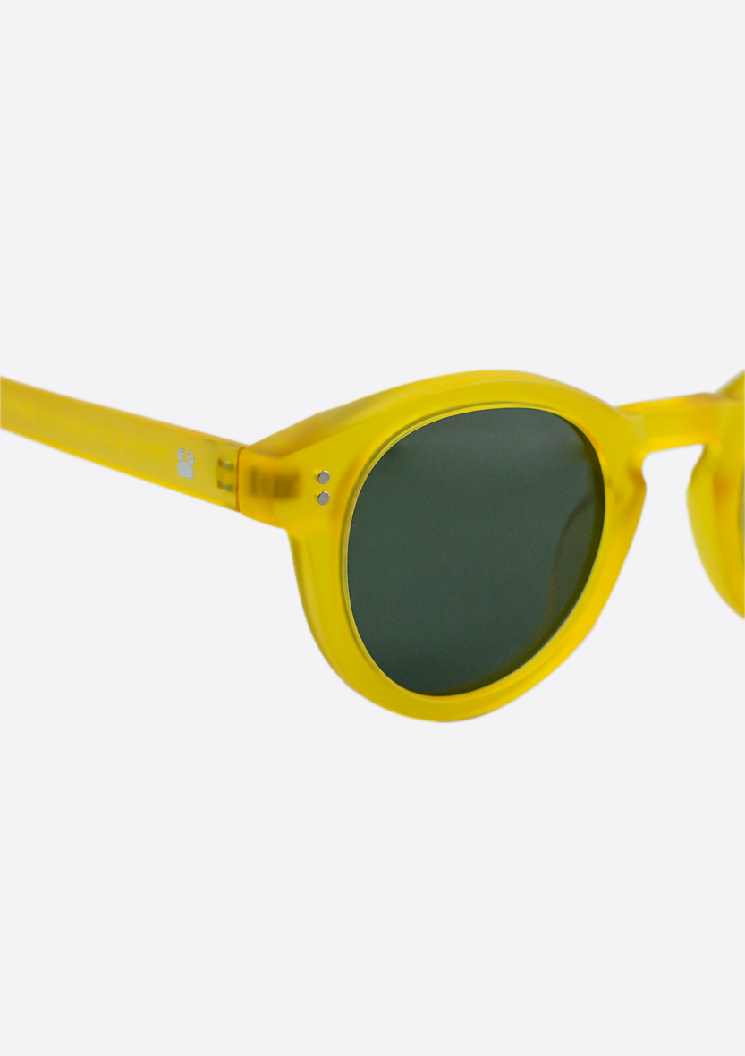 Close-up of Oceanides' Sunglasses (Polarized) - Rodea Yellow Frosted, featuring eco-friendly recycled plastic, bright yellow frosted frames, and dark oval lenses, displayed against a plain white background.