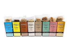 Several colorful boxes of Machado Ondina Crackers with Sesame 125g | Typically Portuguese are neatly arranged in a row, each open to reveal the sesame crackers at the top.