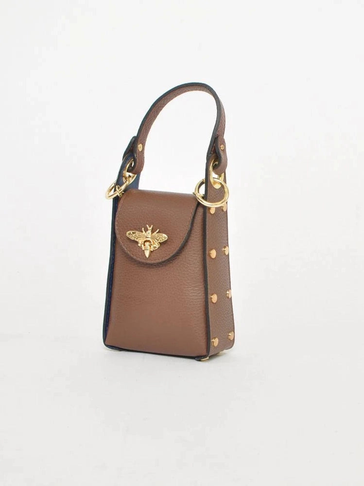 Side angle of Brown Bee bag showing double handles and gold hardware.