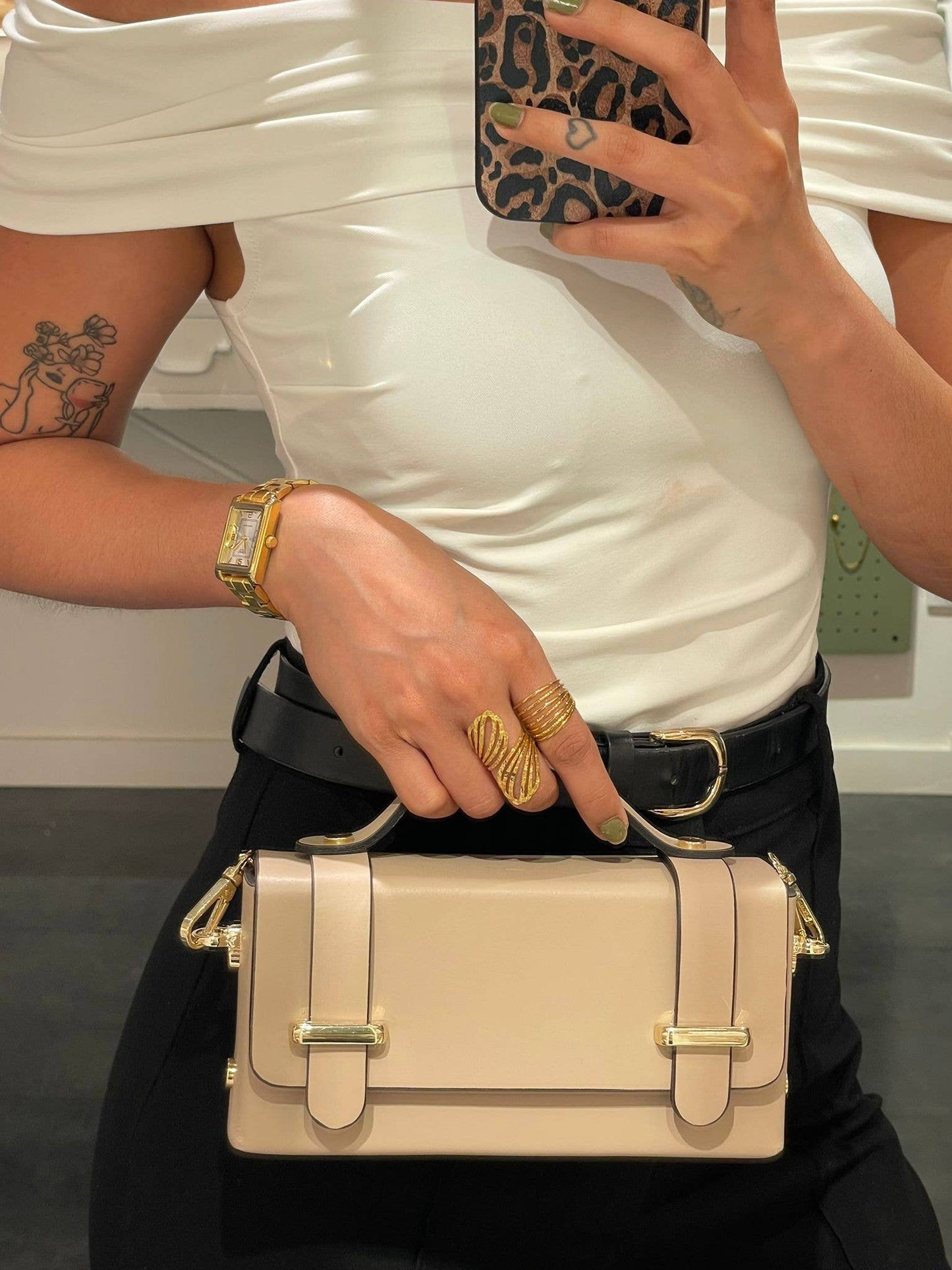 Carmel genuine leather bag in creamy white, front view lifestyle with model taking selfie