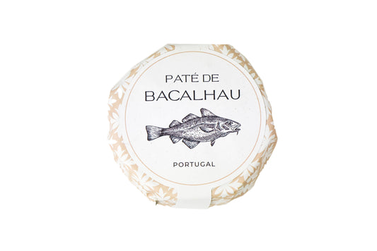 Round package labeled Cod Paté by Machado, featuring a fish illustration and Portugal below, on a white background with a subtle floral border—ideal for fans of high-quality canned fish and gourmet seafood.