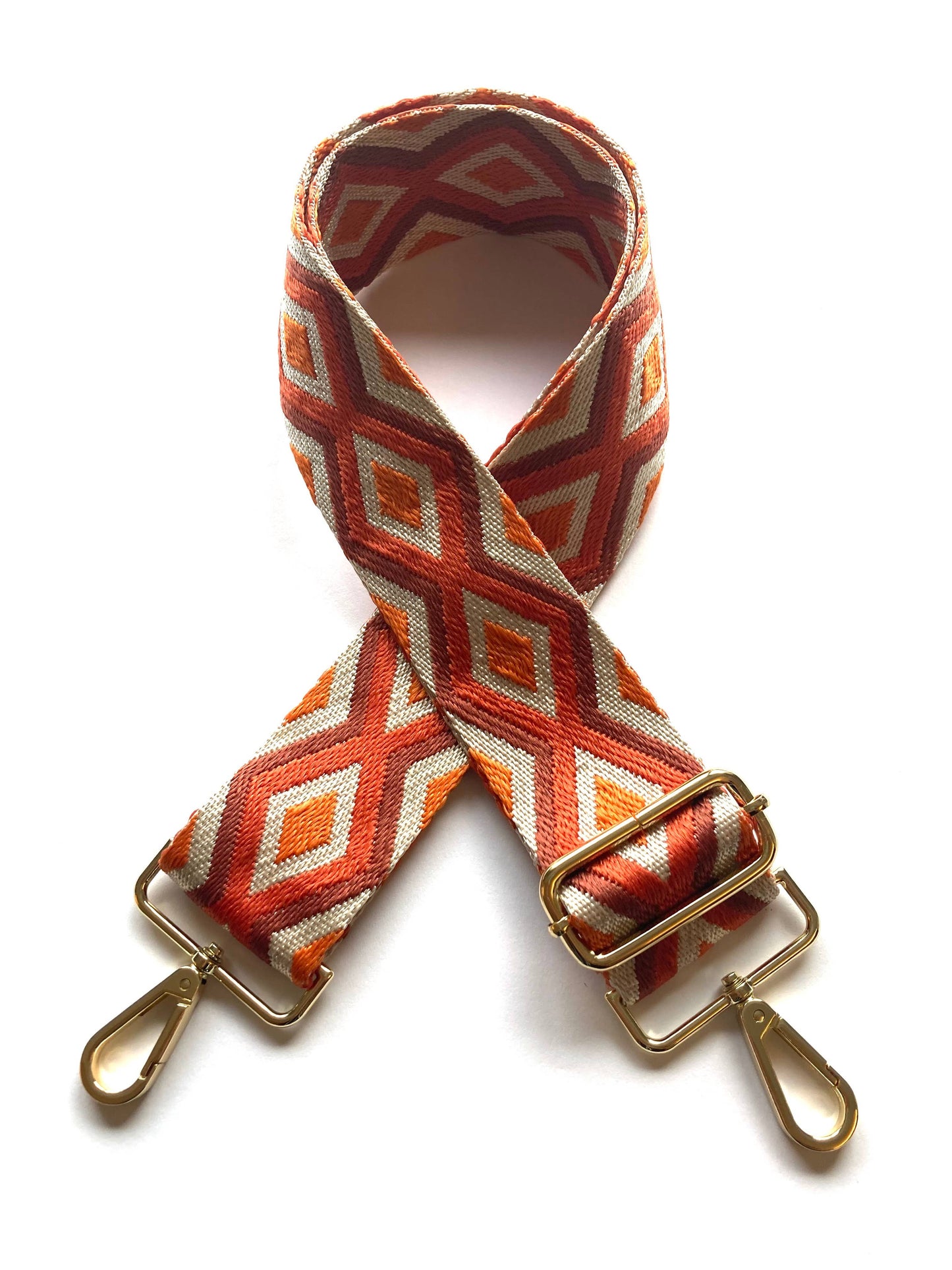 Full-length flat lay of orange, red and beige diamond strap, 60–115 cm adjustable.