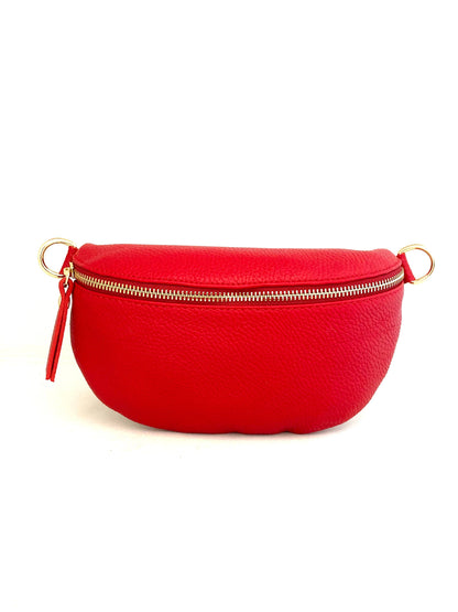 Cassette fanny pack/crossbody in red Italian leather with gold zip and matching strap, front view on white.