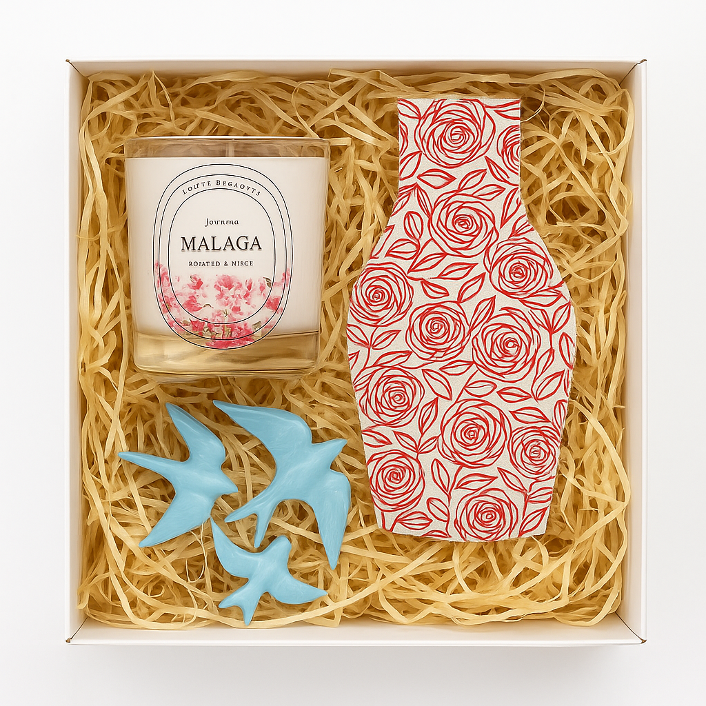The Iberica "Spanish Serenity Gift Box - Malaga" includes a Malaga scented candle, a rose-pattern red-white vase card, and two blue ceramic bird ornaments in a straw-lined box.