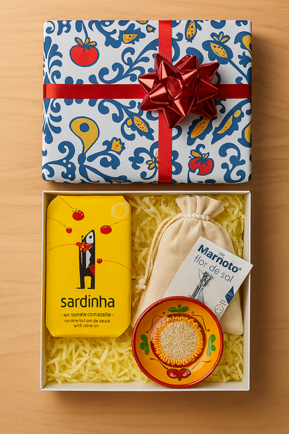 The Iberica - Pretty things from Portugal Iberian sampler kit - Provenzal features a tin of sardines, cloth pouch, Provenzal grater plate, and flor de sal in a gift box with red bow and yellow shredded paper for an authentic Mediterranean touch.