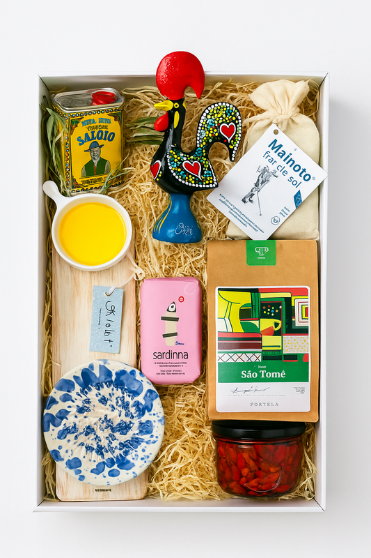 The Iberica Gourmet Hamper #1 by Iberica - Pretty things from Portugal includes olive oil, a ceramic rooster, sea salt, soap, sardines, coffee, a blue dish, wooden board, red peppers, and a pouch—artisanal Portuguese gifts in one beautiful set.