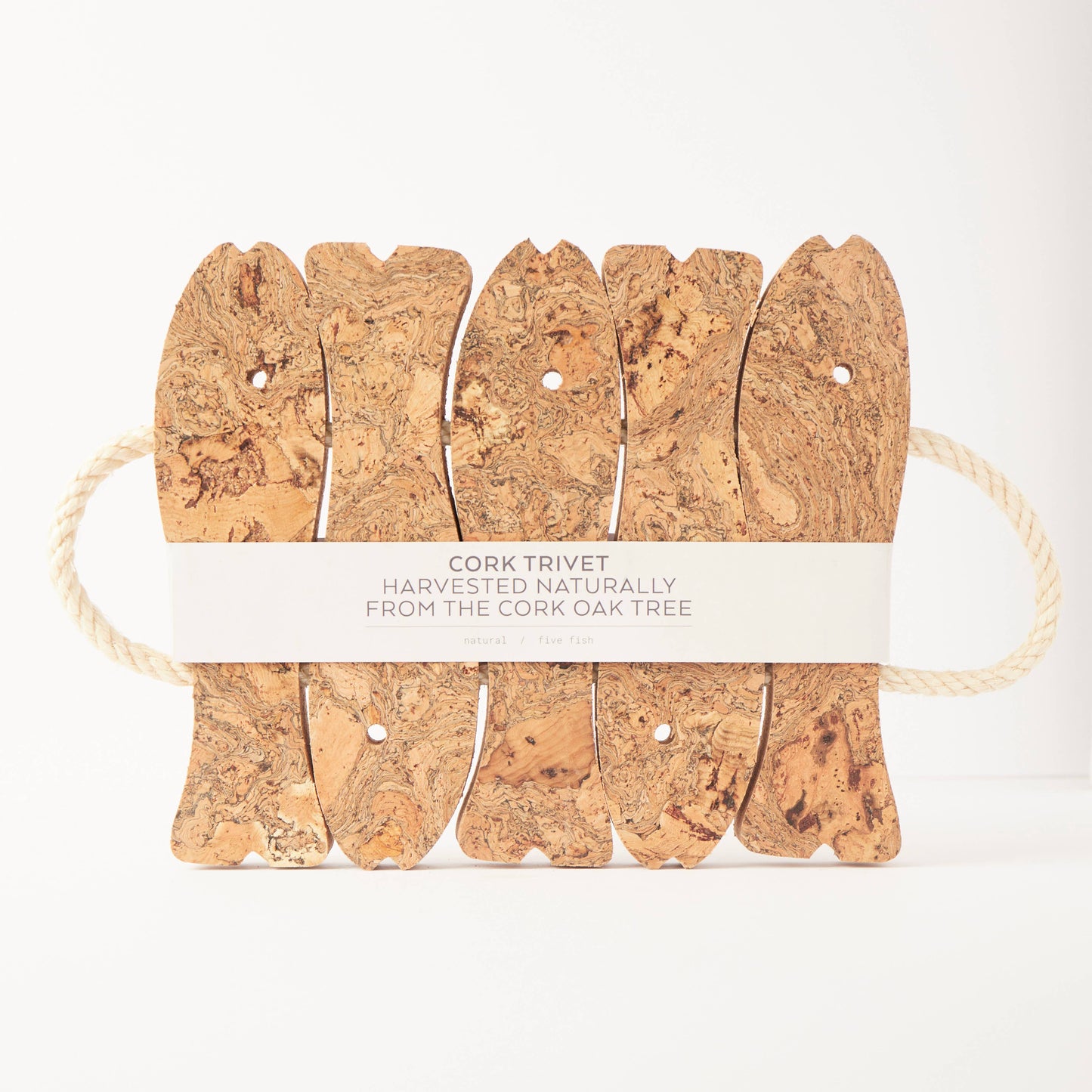 The LIGA Natural Cork Trivet - Fish features five cork pieces connected by rope, with a paper band stating “Cork Trivet Harvested Naturally from the Cork Oak Tree.” Eco-friendly and crafted in Portugal, shown against a white background.