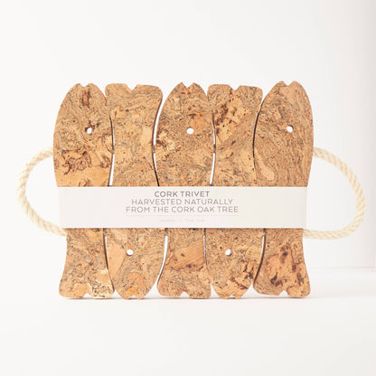 The LIGA Natural Cork Trivet - Fish features five cork pieces connected by rope, with a paper band stating “Cork Trivet Harvested Naturally from the Cork Oak Tree.” Eco-friendly and crafted in Portugal, shown against a white background.