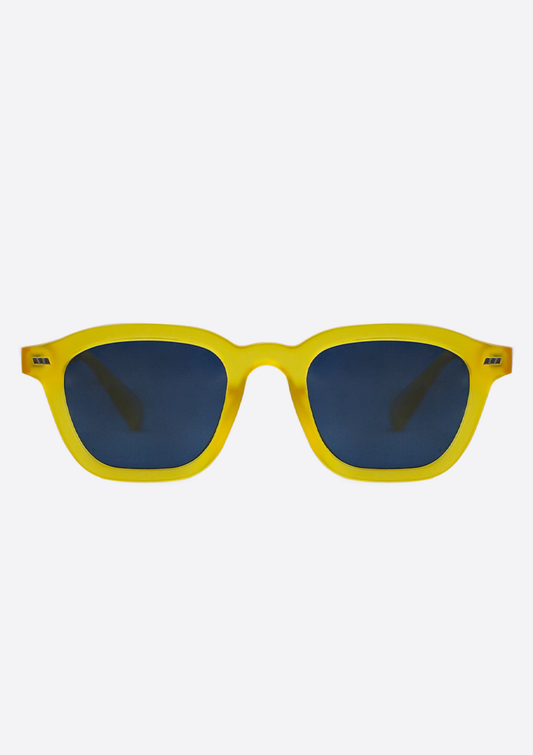 The Oceanides Neda Yellow Frosted Sunglasses feature geometric frames crafted from recycled plastic and dark blue lenses, shown against a plain white background.