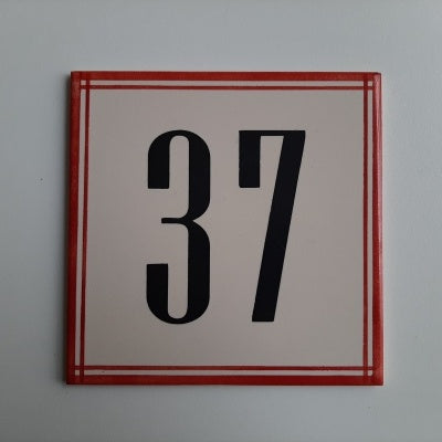 TilePassion’s Handpainted Ceramic Door Numbers – Custom Portuguese Tiles feature a square tile with a thin red border and a bold black 37 in the center, evoking classic ceramic door numbers on a white background.