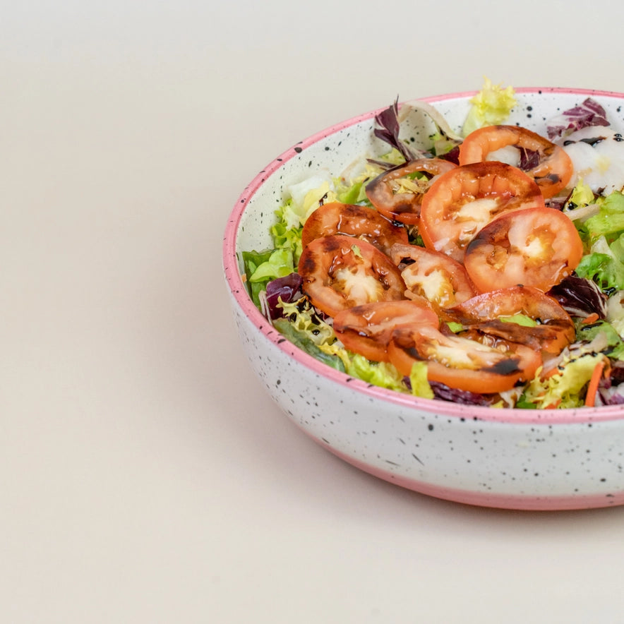 rose salad bowl with salada and white background