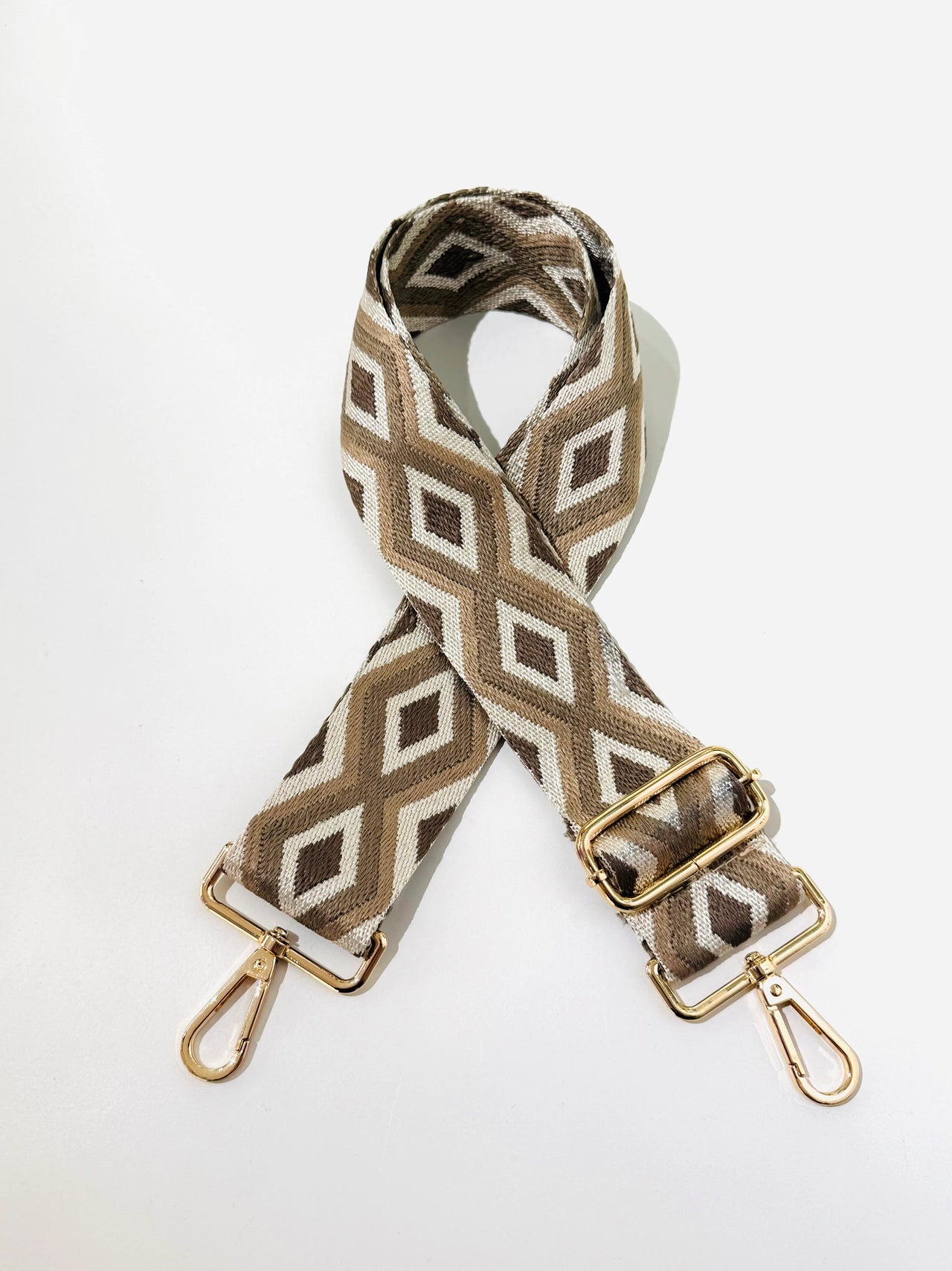 Woven bag strap with geometric pattern on a white background