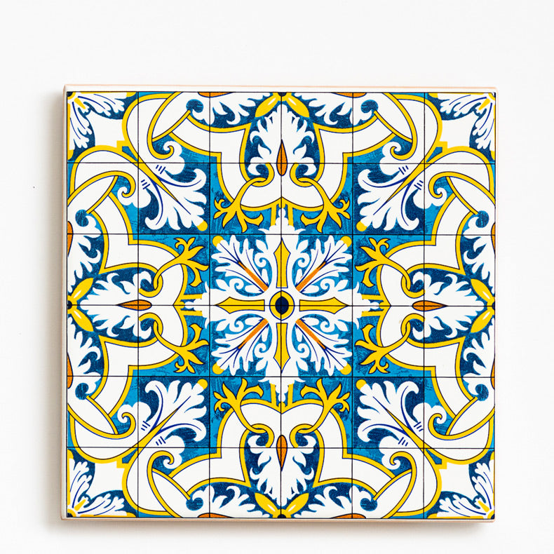 The Ceramic drinks coaster 11cm - Azulejo 23 by ObjectoAnonimo features a vibrant blue, yellow, and white Portuguese azulejo-inspired pattern with ornate floral and geometric shapes.