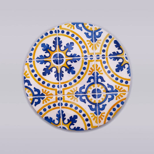 hand painted tile with blue and yellow motif