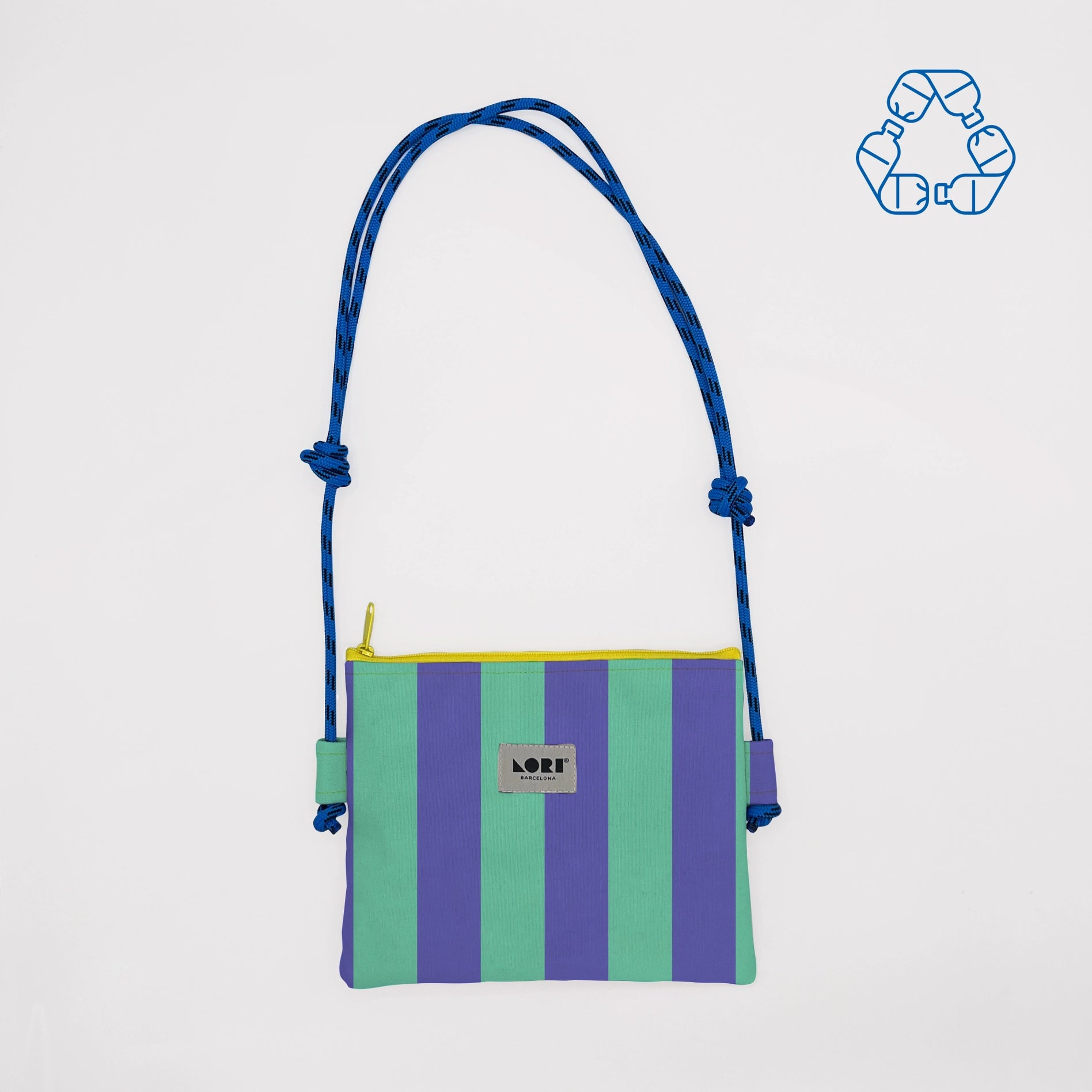 A striped crossbody bag with vertical purple and mint green stripes, a blue rope shoulder strap, and a yellow zipper trim. The brand label reads 'LOFT'.