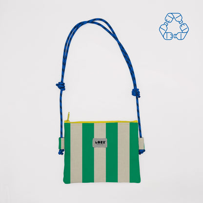 A small crossbody bag with vertical green and cream stripes, a blue braided shoulder strap, and a yellow zipper, shown on a light gray background with a blue recycling icon in the top right corner.