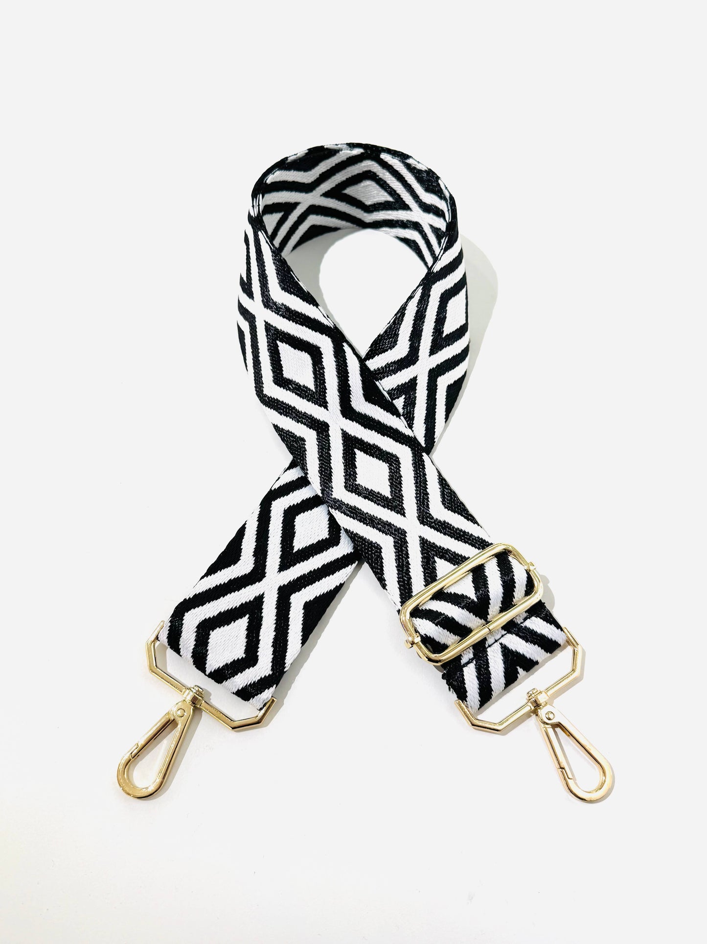 Full-length flat lay of black and white  diamond strap, 60–115 cm adjustable.