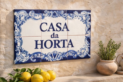 Decorative tile with 'Casa da Horta' text on a stone wall with lemons and a plant.
