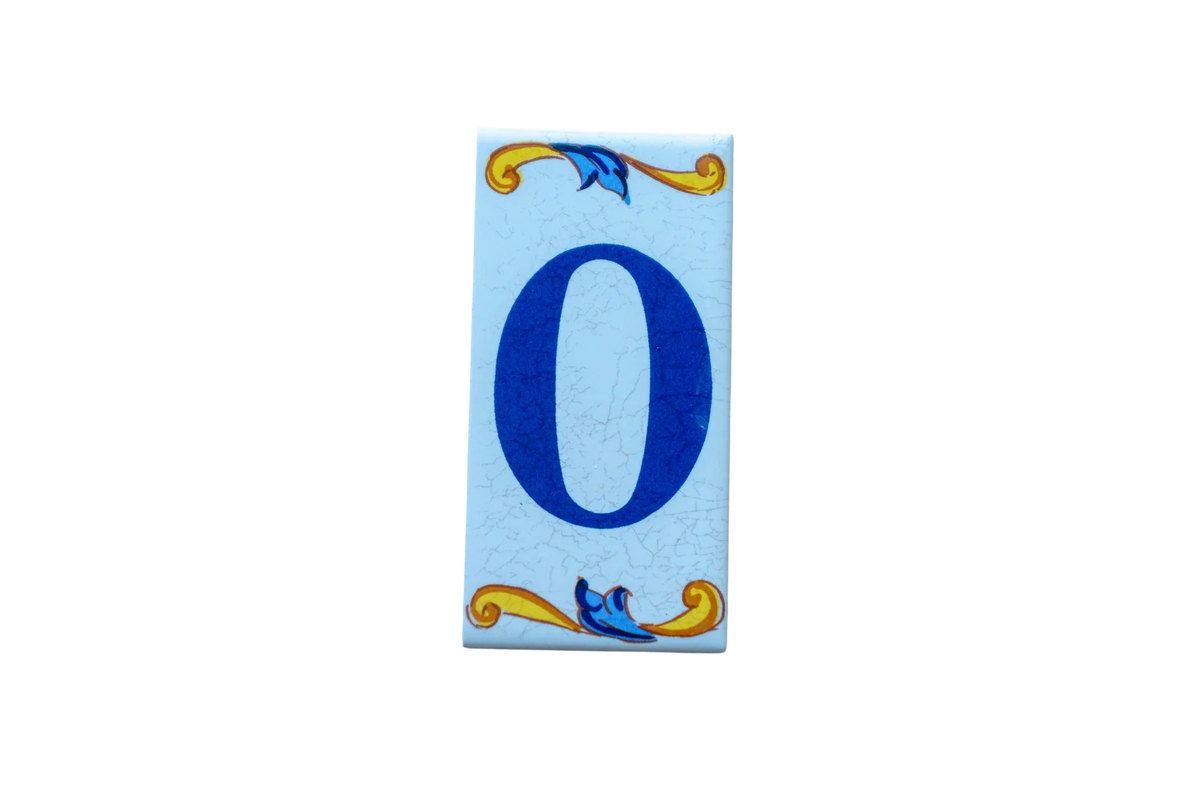 Lisa Croquets Letters – Ceramic House Letter Tile featuring the number zero in blue, with rectangular handcrafted edges and decorative blue and yellow scrollwork at the top and bottom.