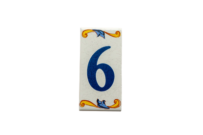 Lisa Croquets Numbers – Ceramic House Number Tile in a rectangular shape featuring the number six in blue, decorated with yellow and blue scrollwork borders.