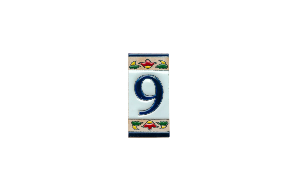Mini Chilli Ceramic House Number & Letter Tile: a handcrafted Spanish rectangular ceramic tile featuring the number nine in navy blue, bordered by a floral pattern in red, green, and tan.