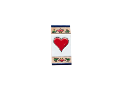 Mini Chilli Ceramic House Number & Letter Tile featuring a red heart in the center with a decorative floral border at the top and bottom in the style of handcrafted Spanish tiles.