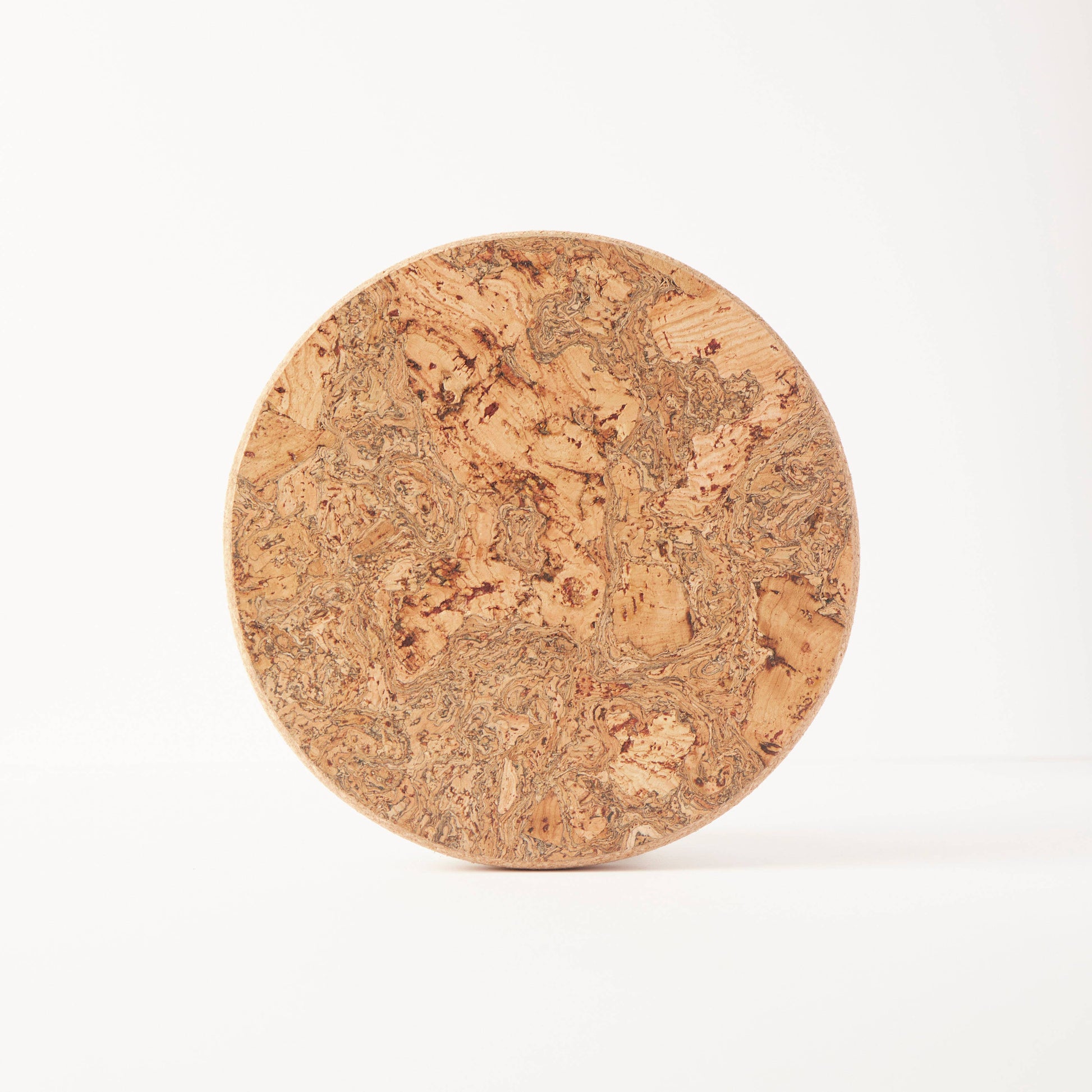 The LIGA Natural Cork Trivet - Round Small is shown upright on a plain white background, featuring a textured surface that highlights its eco sustainable homeware design and heat-resistant properties.