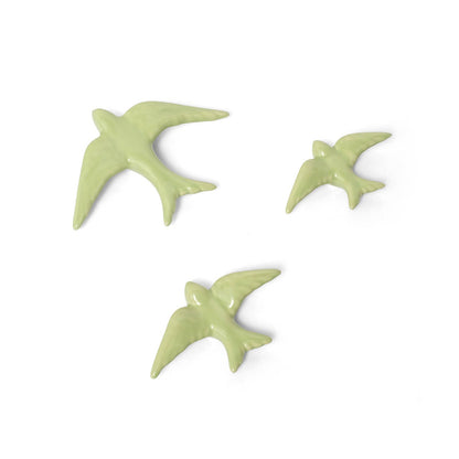 The Casa Atlantica Ceramic Swallows - Set of 3 New Colours features charming ceramic swallows in varying sizes, arranged as if in flight, perfect for adding a touch of Mediterranean style to your wall decor.