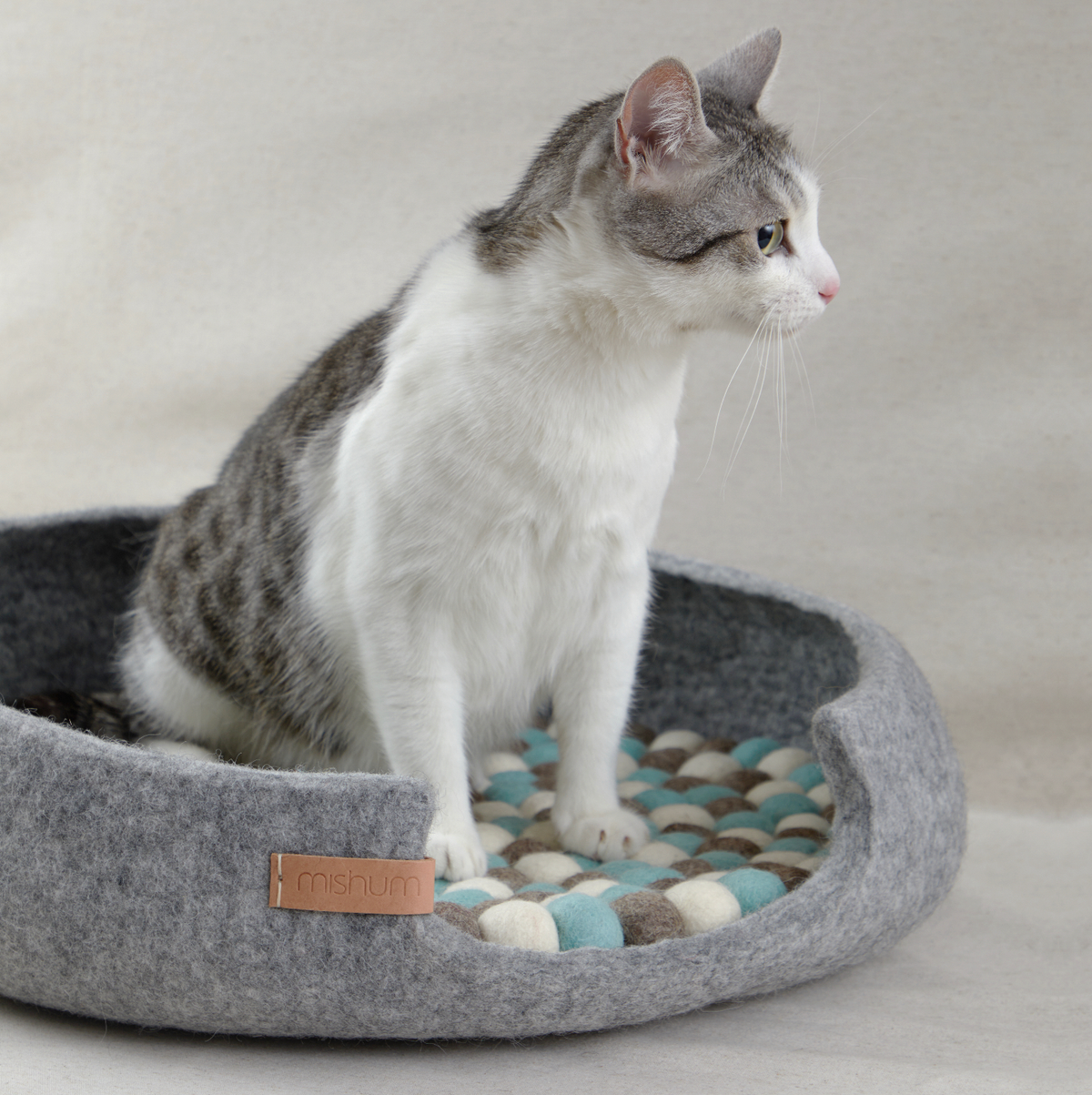 Simona silver wool felt pet bed with cat resting inside