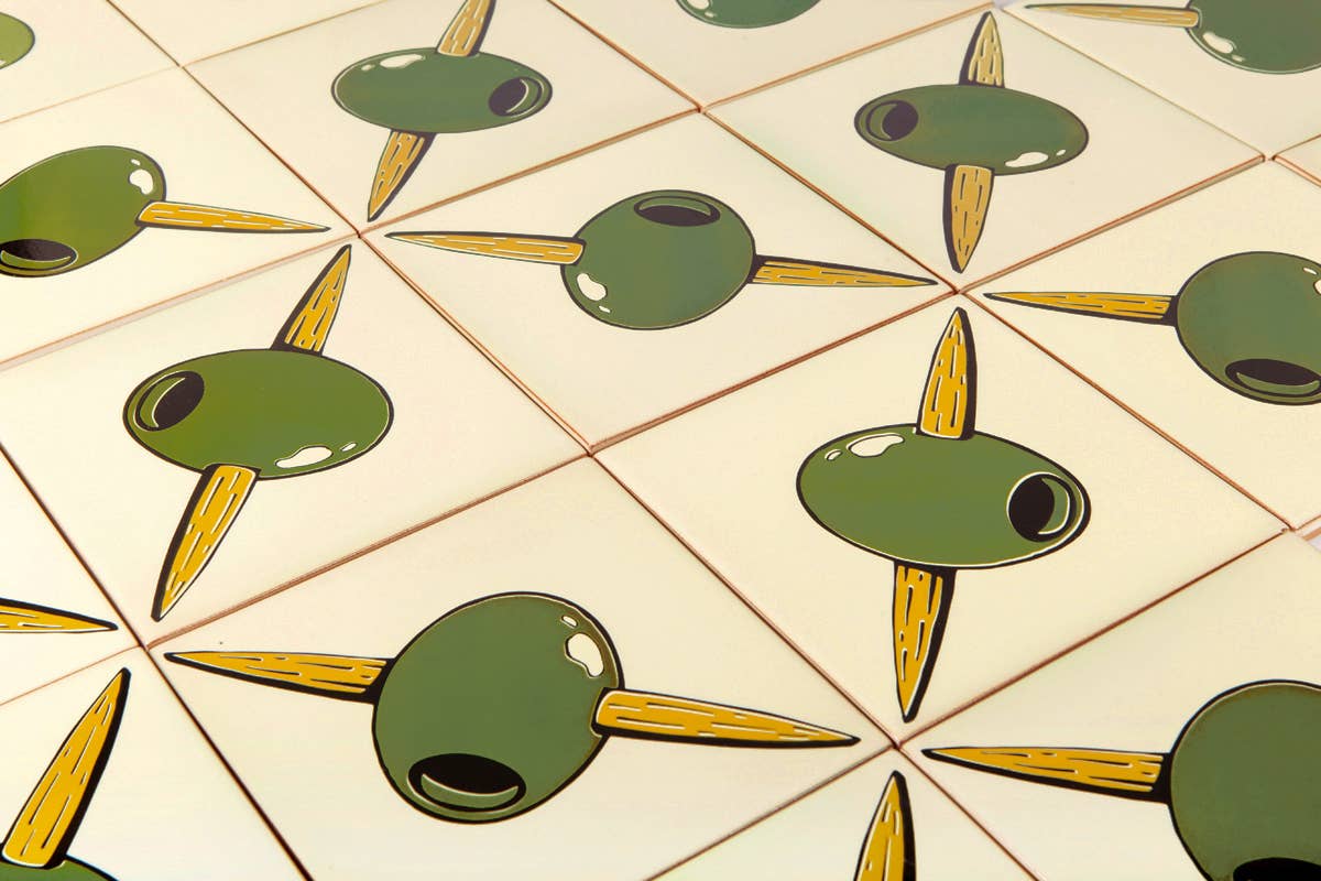 Angled view of Spanish olive branch ceramic tiles with self-adhesive backing