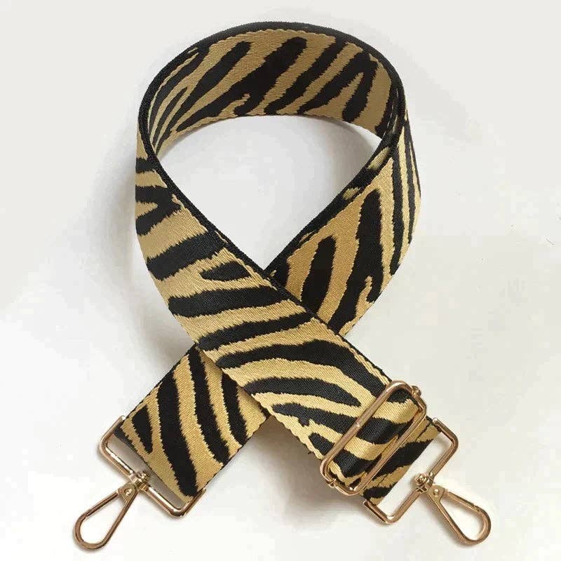 Gold clip ends on zebra patterned strap, universal clips for most bags.