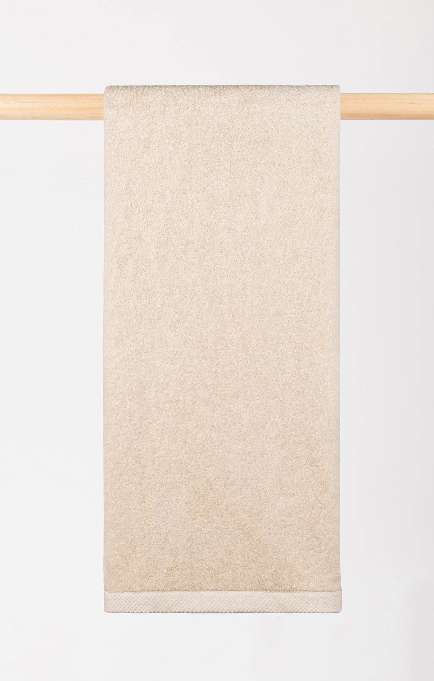 Close-up image of Natural Torres Novas X Zero bath towel hanging on a rail